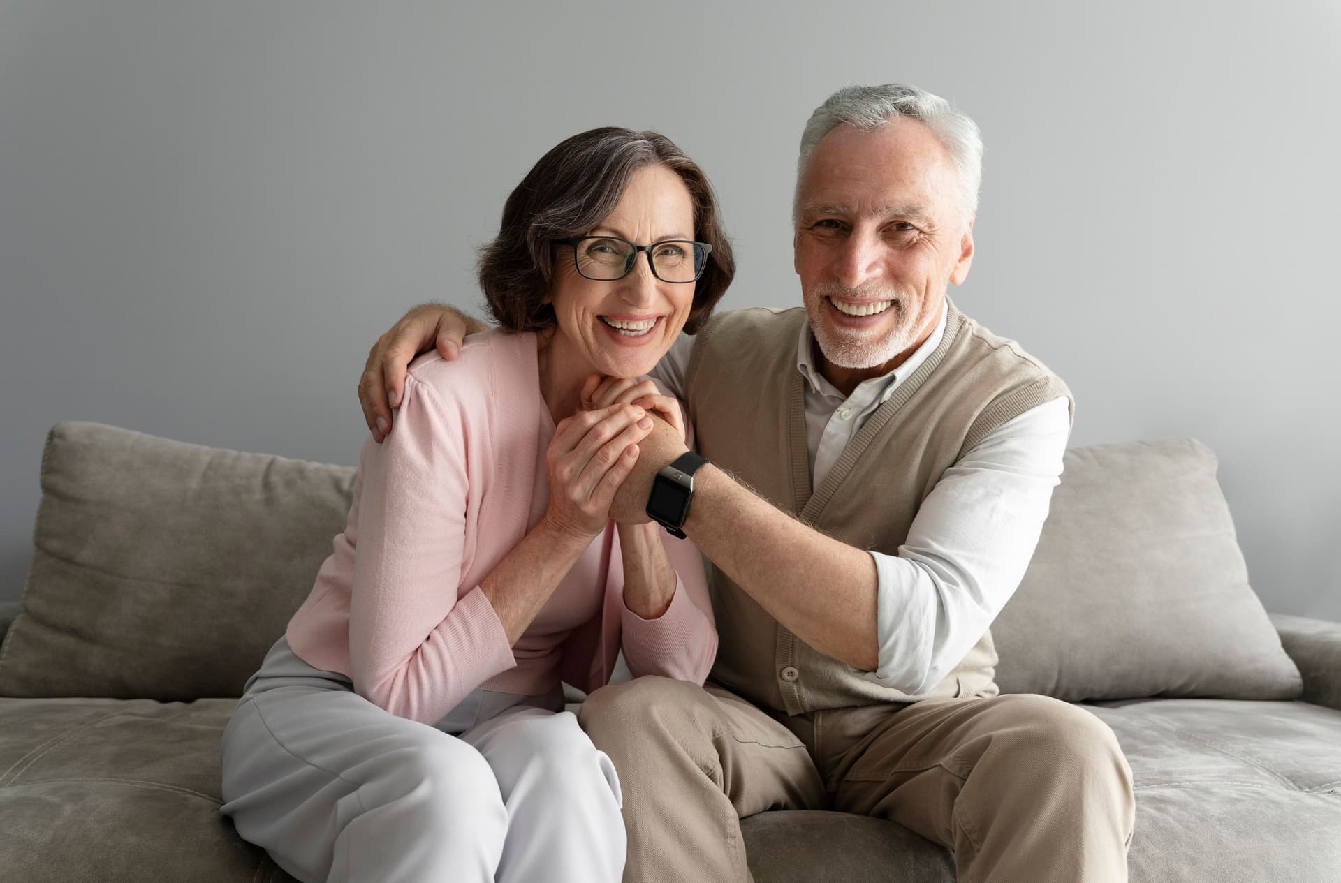 Elderly couple embracing and smiling