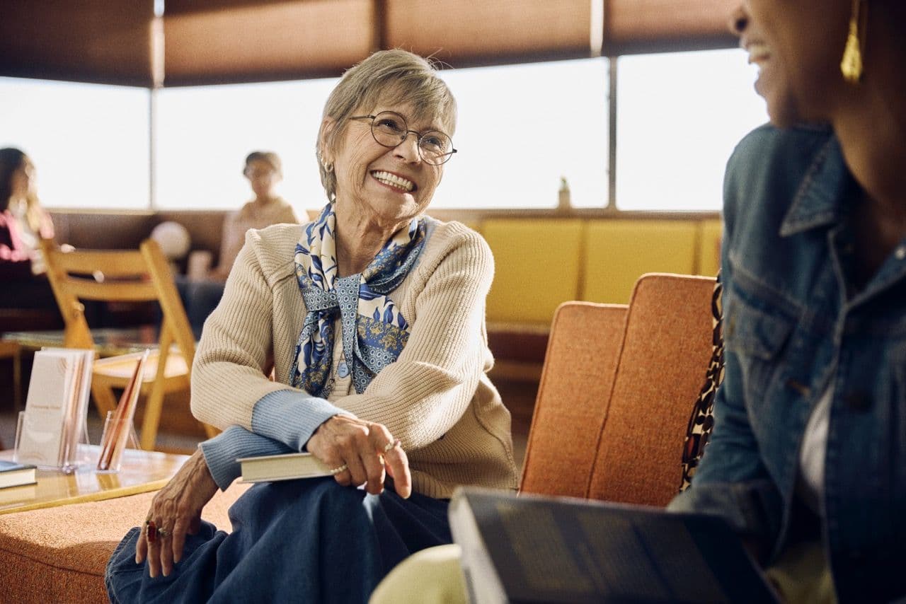 Woman enjoying conversation with another woman